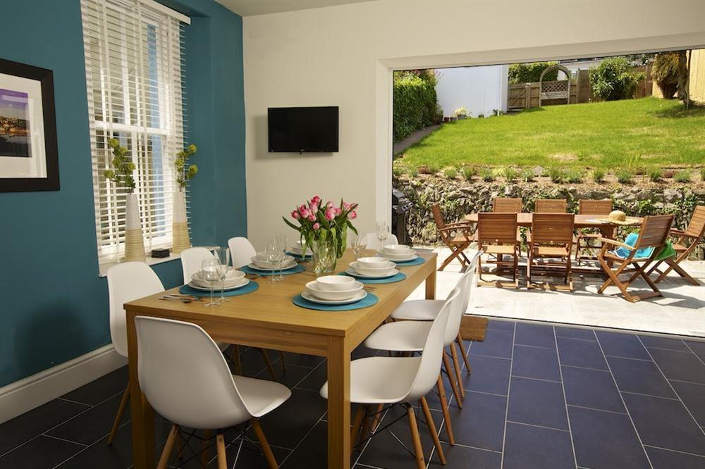 Dining area with folding doors out to the rear terrace and garden at Sandpiper in , Salcombe