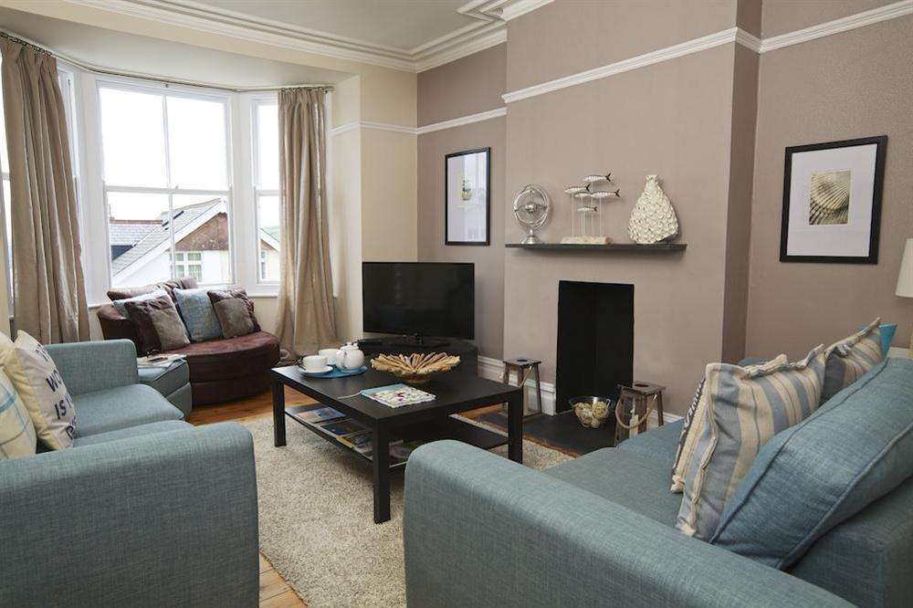 Sitting room with feature bay window and estuary views between houses at Sandpiper in , Salcombe