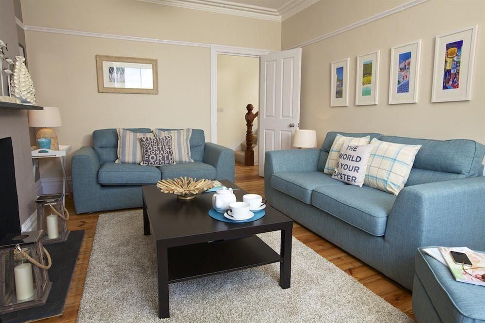 Stylishly furnished and attractively decorated sitting room with two large sofas at Sandpiper in , Salcombe