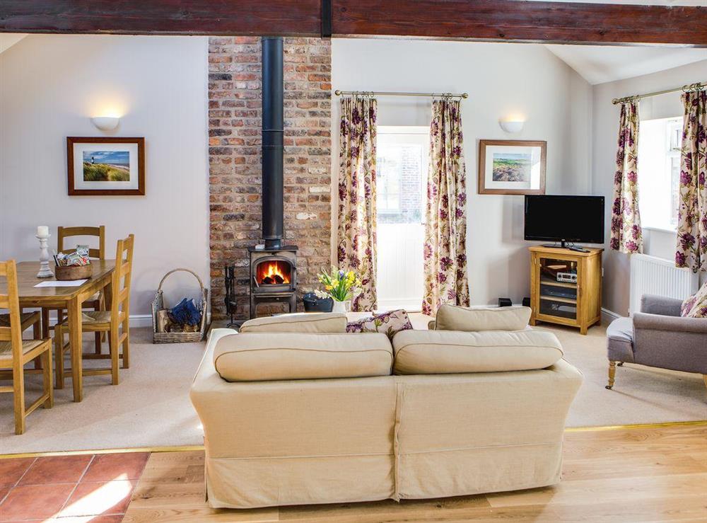 Large beamed open plan living room with wood-burning stove and vaulted ceiling at Sandpiper in Scalby, Scarborough, N. Yorks., North Yorkshire