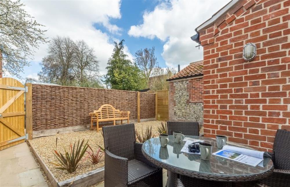 The sunny rear garden has a table with seating for five at Sandpipers Cottage, South Creake near Fakenham