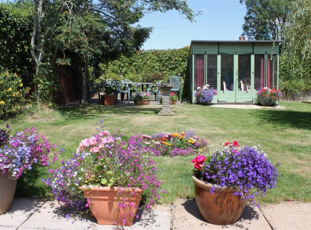 Garden with summerhouse and seating area at Sandringham Heights in Paignton, Devon