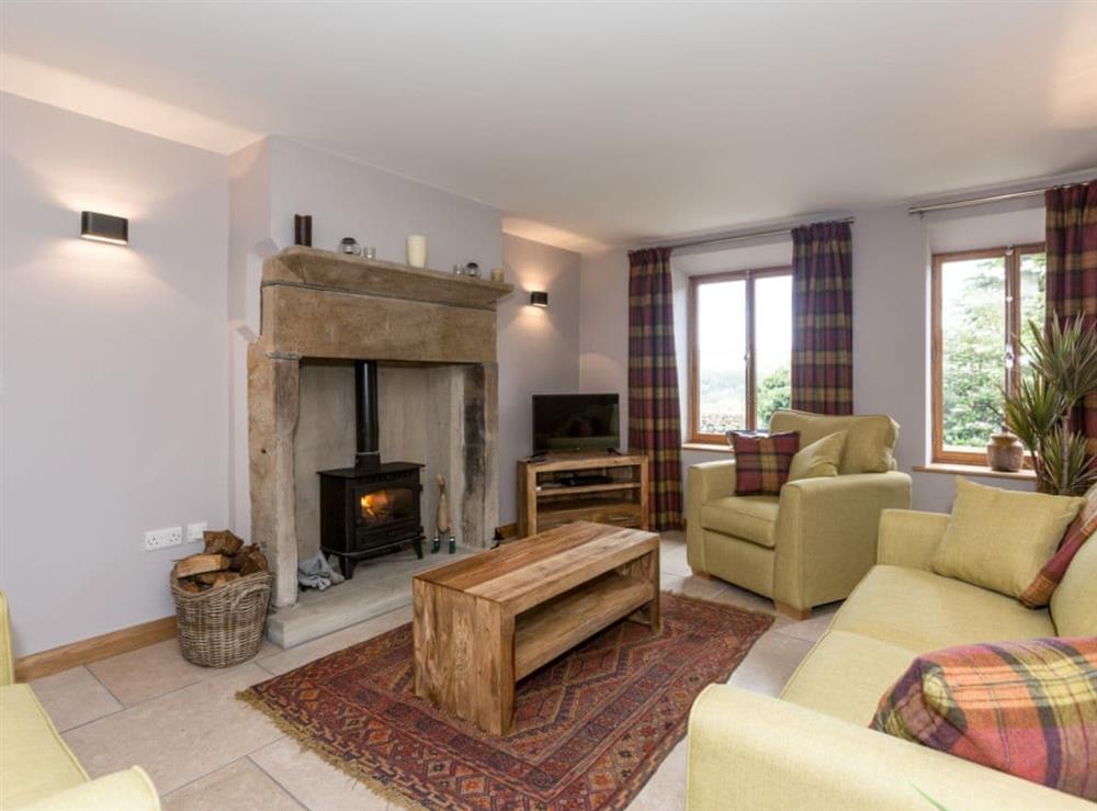 Cosy living room with wood burner at Sands Farm Cottage in Luddendenfoot, near Hebden Bridge, West Yorkshire