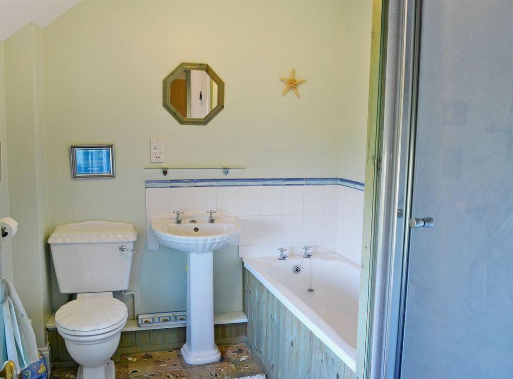 Bathroom with bath, separate shower cubicle, WC and wash basin at Sandsedge Cottage in Morpeth, Northumberland