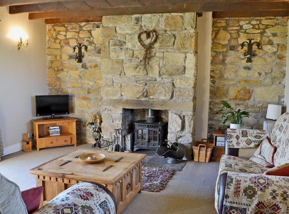 Living room with exposed beams and stone work at Sandsedge Cottage in Morpeth, Northumberland