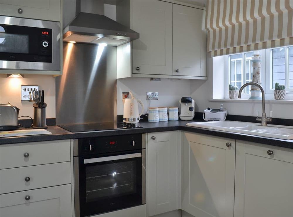 Charming and practical kitchen layout at Sandy Bay Beach House in The Bay, Filey, North Yorkshire