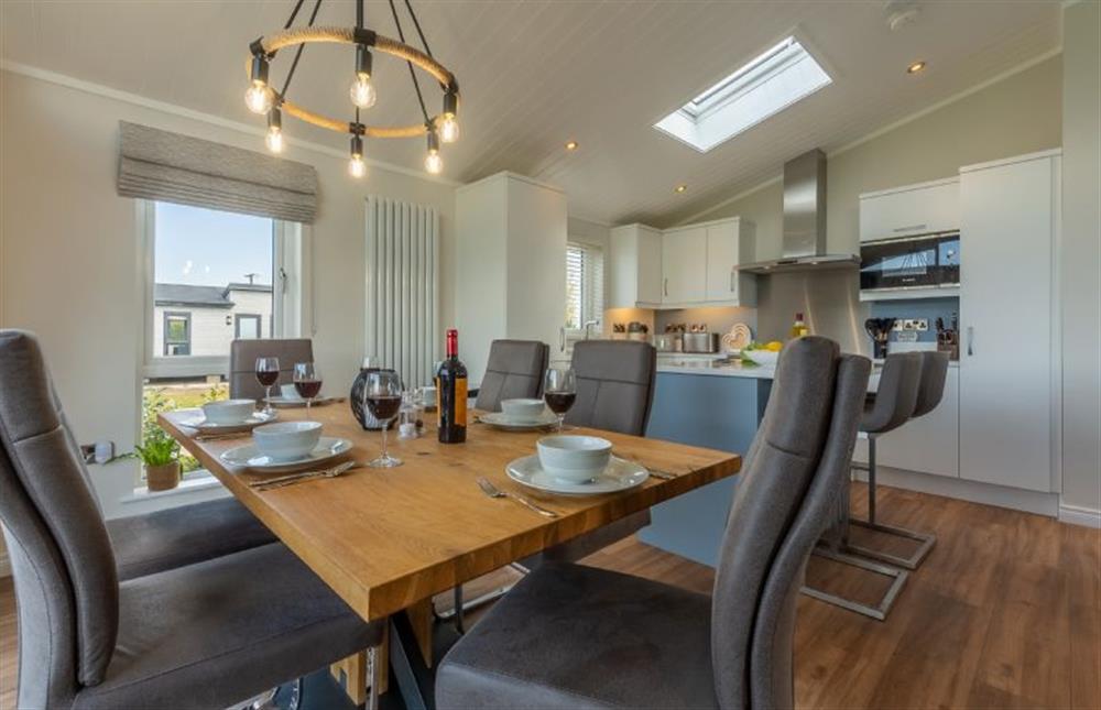 Ground floor: Dining area with kitchen beyond at Sandy Toes, Burnham Market near Kings Lynn