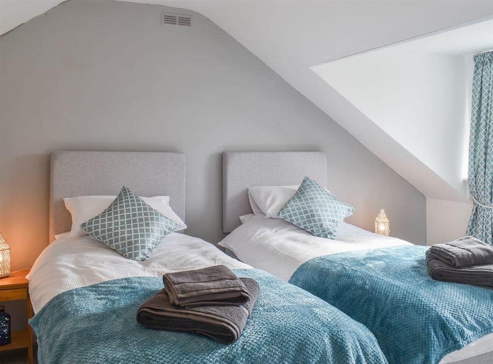 Pretty twin bedroom under the eaves at Sandy Toes in Whitby, North Yorkshire