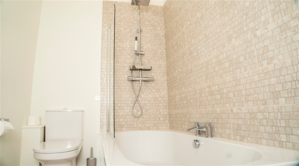 The bathroom, with shower over bath, on the first floor of Sandybury Barn, Shropshire at Sandybury Barn in Bridgnorth, Shropshire