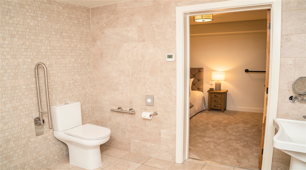 The entrance to the accessible wet room from the ground-floor double bedroom at Sandybury Barn in Bridgnorth, Shropshire