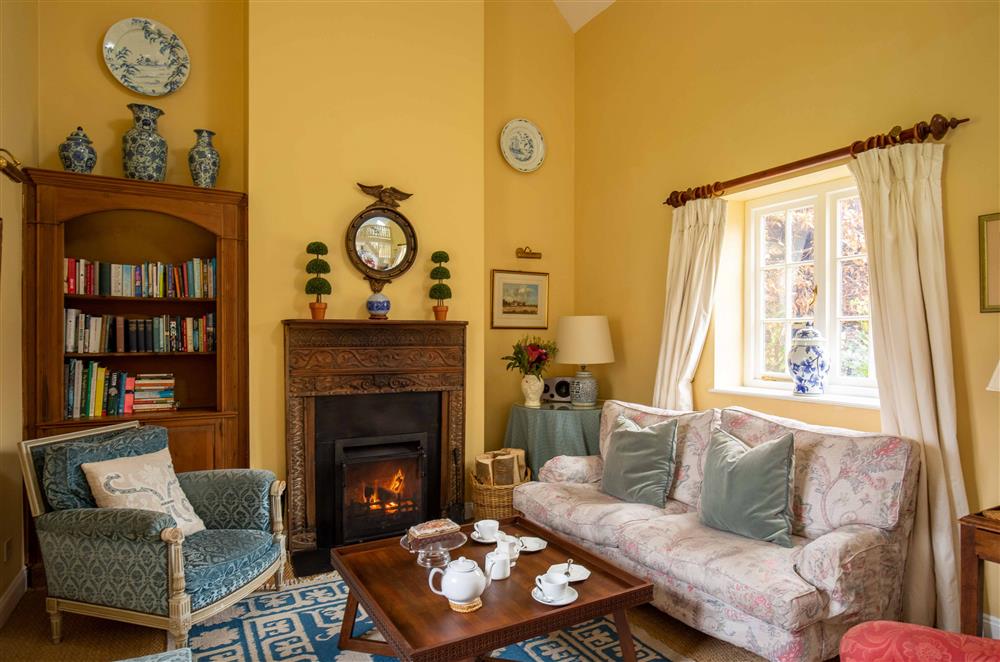 Relax in front of the open-fire in the sitting area at Saratoga Cottage, Bruern, near Chipping Norton