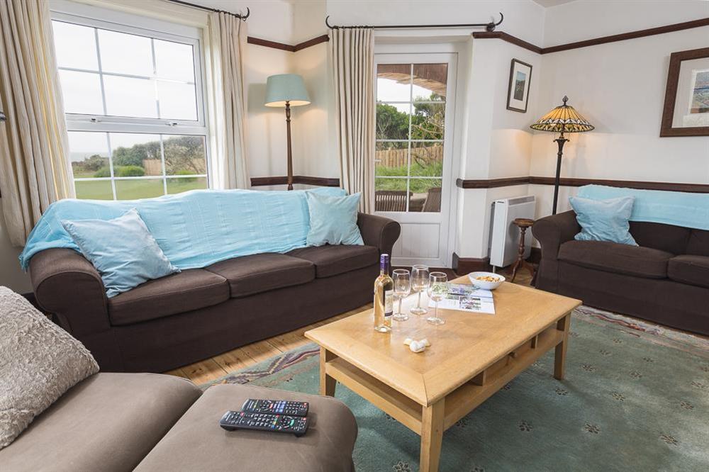 A comfortably furnished sitting room with lovely views and door out to the terrace & garden (photo 2) at Savernake in , Thurlestone
