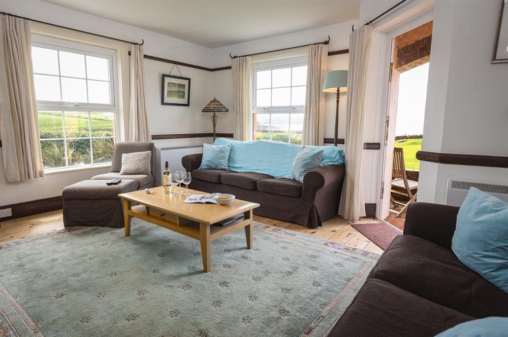 A comfortably furnished sitting room with lovely views and door out to the terrace & garden at Savernake in , Thurlestone