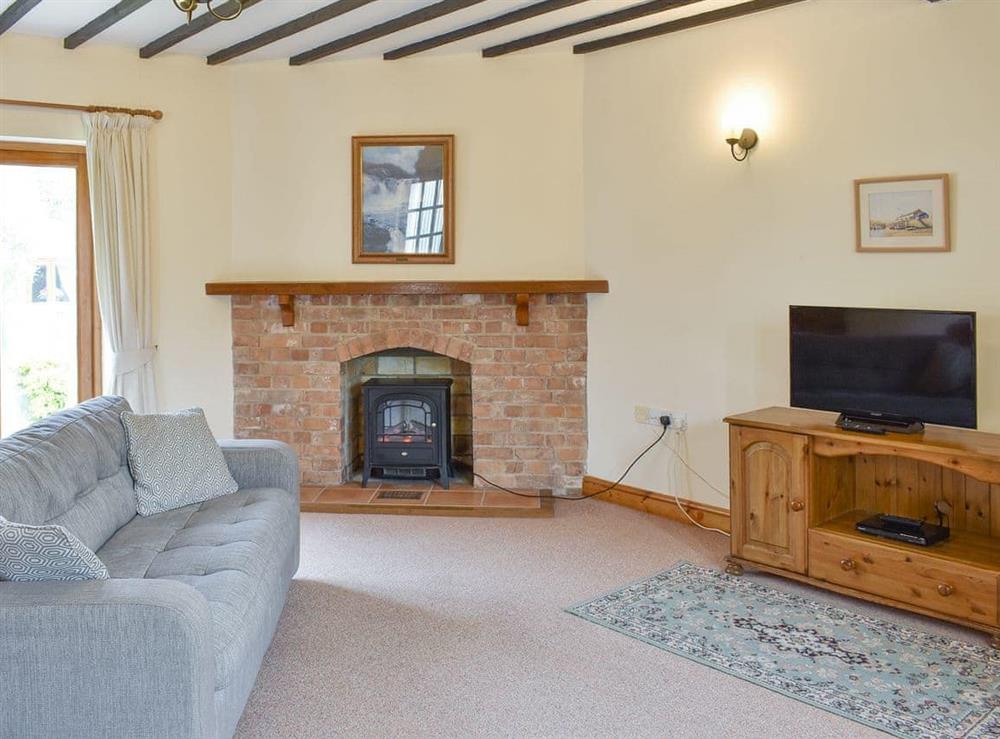 Characterful living room with beamed ceiling at Sawmill Cottage in Puncknowle, Dorchester., Dorset