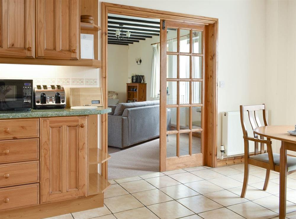 Living room adjoins the kitchen/diner at Sawmill Cottage in Puncknowle, Dorchester., Dorset