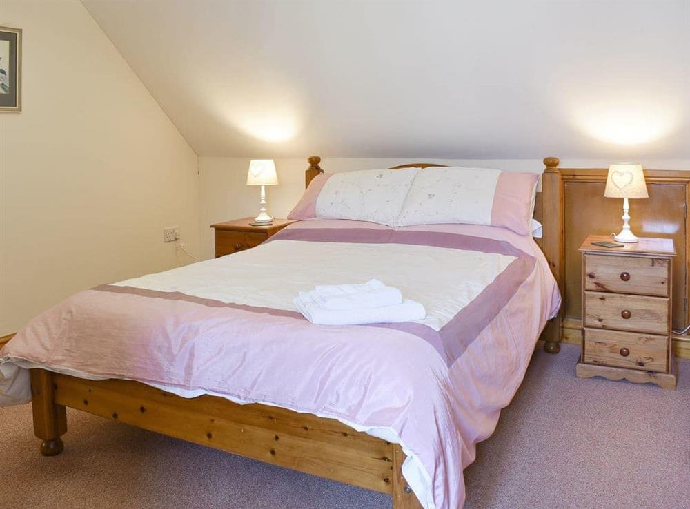 Relaxing double bedroom with en-suite bathroom at Sawmill Cottage in Puncknowle, Dorchester., Dorset