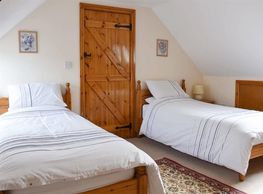 Twin beds within the en-suite triple bedroom at Sawmill Cottage in Puncknowle, Dorchester., Dorset