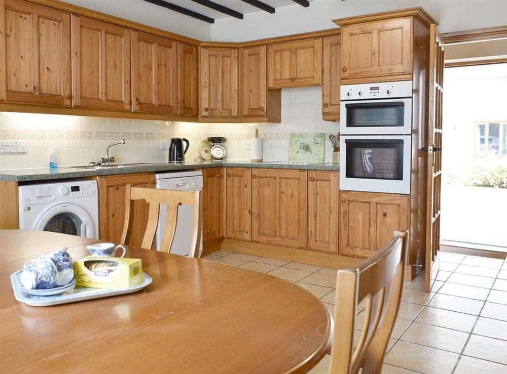 Well-equipped kitchen with dining area at Sawmill Cottage in Puncknowle, Dorchester., Dorset