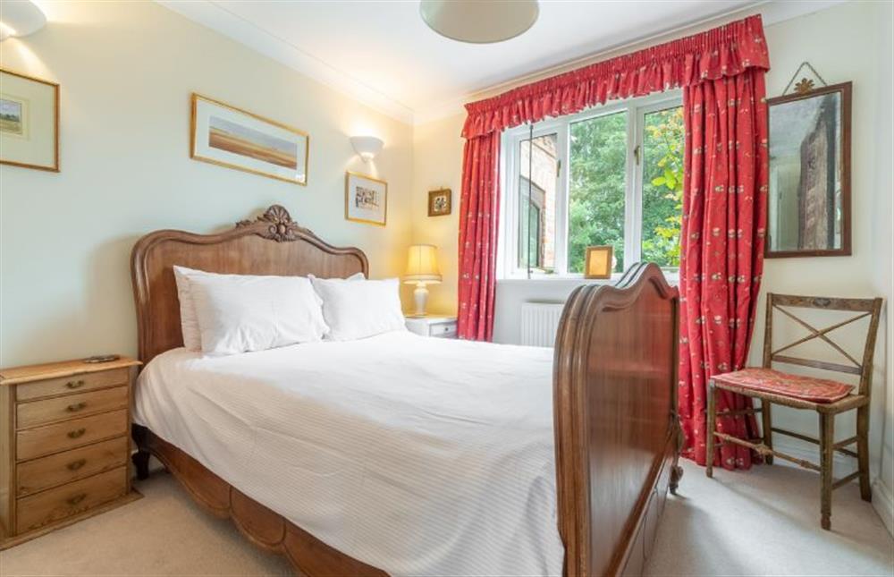 Ground floor: Bedroom one, with antique double bed  at Saxon Shore Cottage, Burnham Deepdale near Kings Lynn