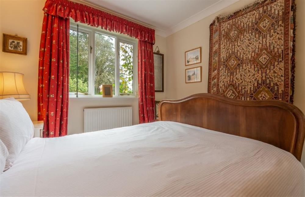 Ground floor: Bedroom one, with double bed and wardrobe at Saxon Shore Cottage, Burnham Deepdale near Kings Lynn