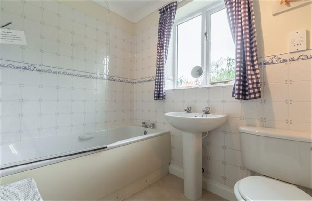 Ground floor: Family bathroom with shower over at Saxon Shore Cottage, Burnham Deepdale near Kings Lynn