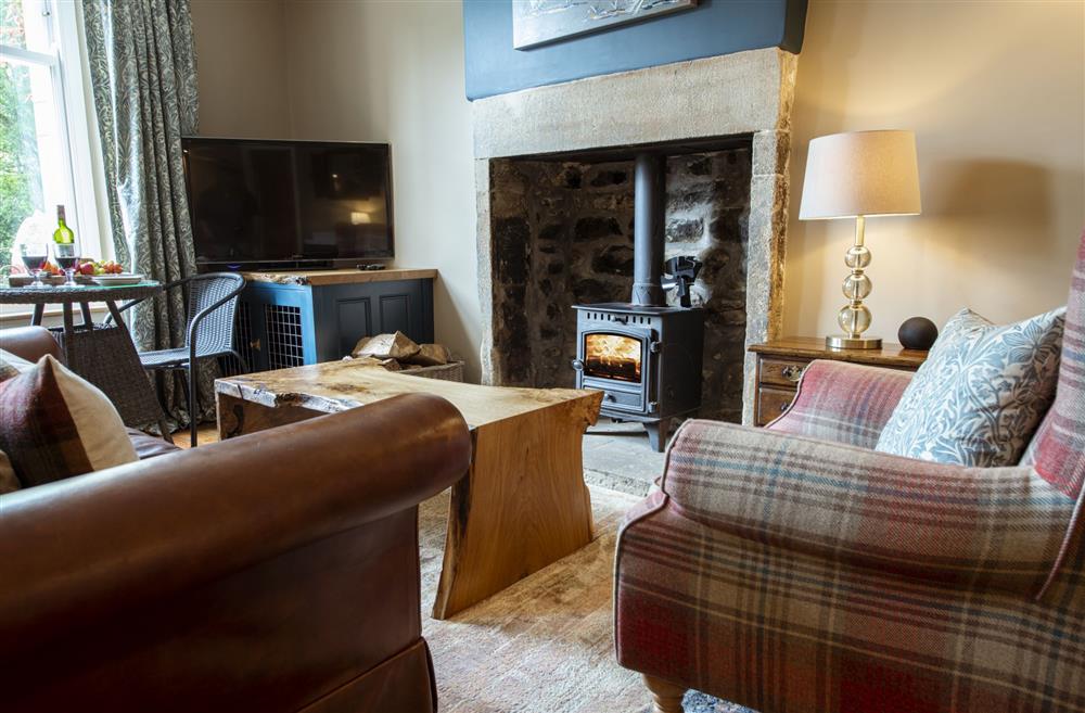 The warm and cosy wood burning stove in the sitting room at Scala Glen Cottage, Skipton