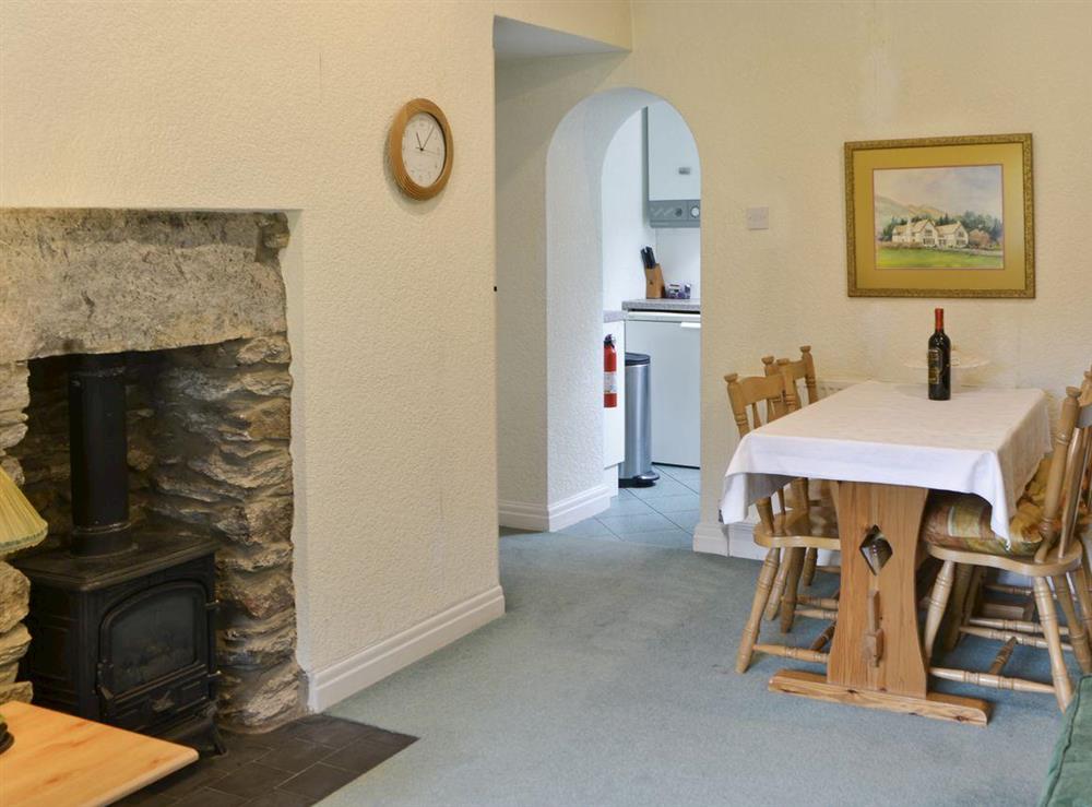 Heritage fireplace and intimate dining area at Scarfell Apartment in Ambleside, Cumbria