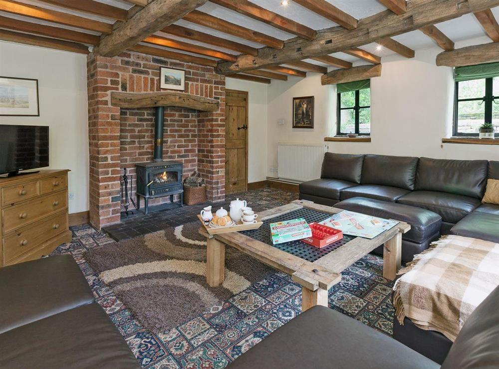 Luxurious living room with woodburner and beamed ceiling at School House in Bradnop, near Leek, Staffordshire