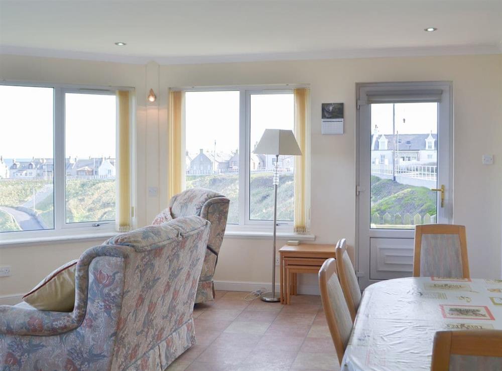 Sun room with dining area and dramatic views over the town at White Gables, 