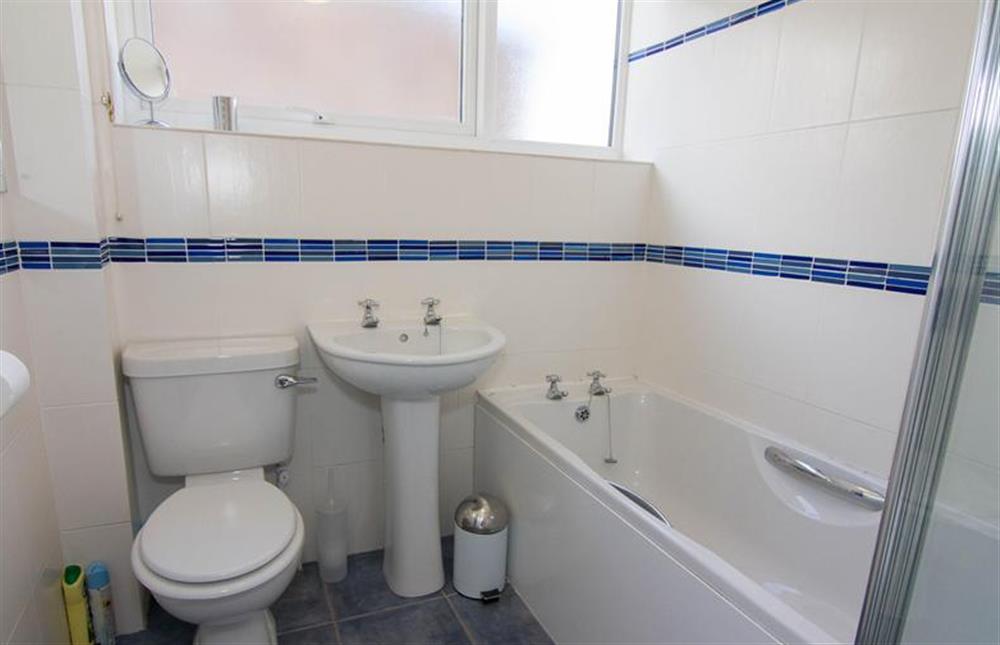 First floor: Family bathroom has bath with shower over at Sea Aster, Brancaster Staithe near Kings Lynn