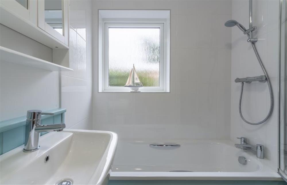 Ground floor:  Bathroom with bath with shower over at Sea Breeze, Brancaster near Kings Lynn