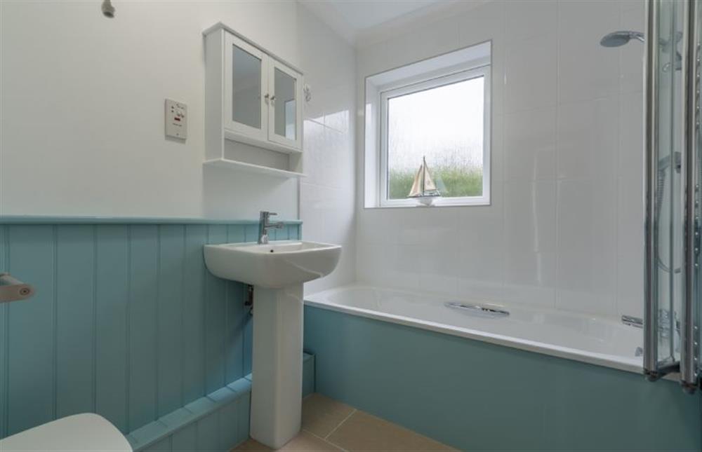 Ground floor:  Bathroom with feature wood panelling at Sea Breeze, Brancaster near Kings Lynn