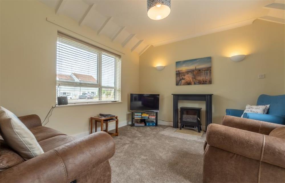 Ground floor:  Sitting area with comfy sofas and flatscreen television at Sea Breeze, Brancaster near Kings Lynn