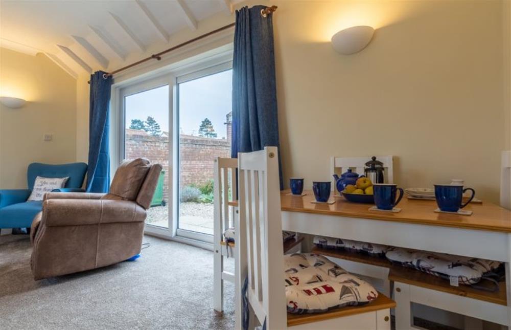 Ground floor: Sitting/ dining room with table with seating for four at Sea Breeze, Brancaster near Kings Lynn