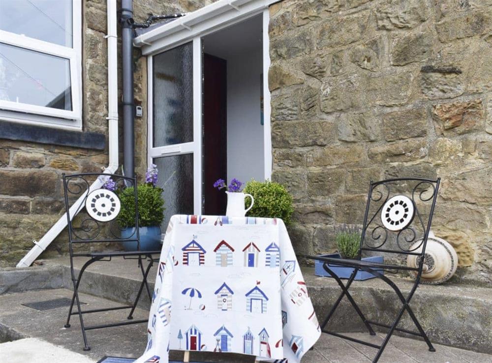 Small sitting-out area with garden furniture at Sea Breeze Cottage in Cowbar, near Staithes, North Yorkshire