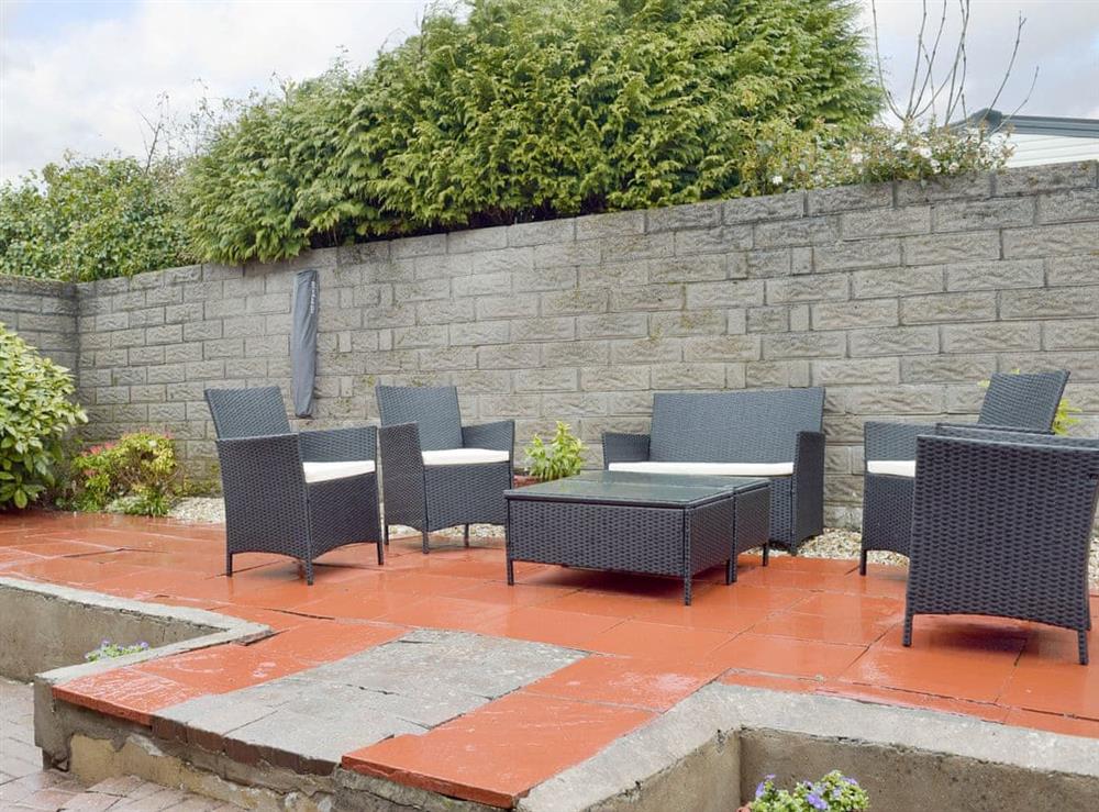 Large patio with outdoor furniture at Sea Breeze in The Mumbles, Glamorgan, West Glamorgan