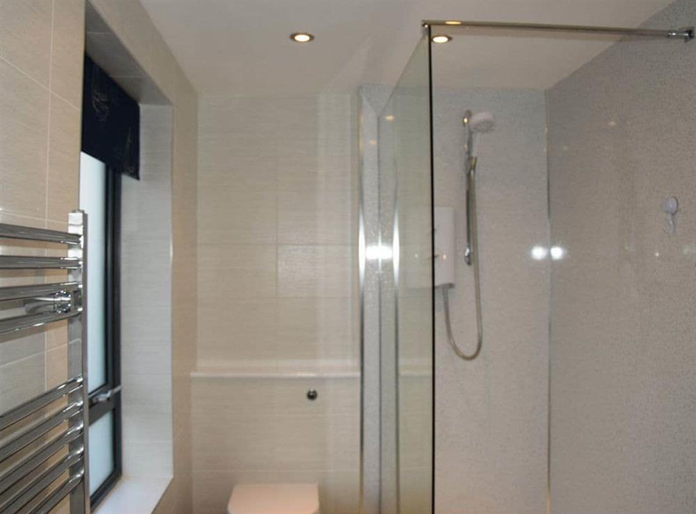 Shower room with walk-in shower and heated towel rail at Sea Drift in West Bay, near Bridport, Dorset