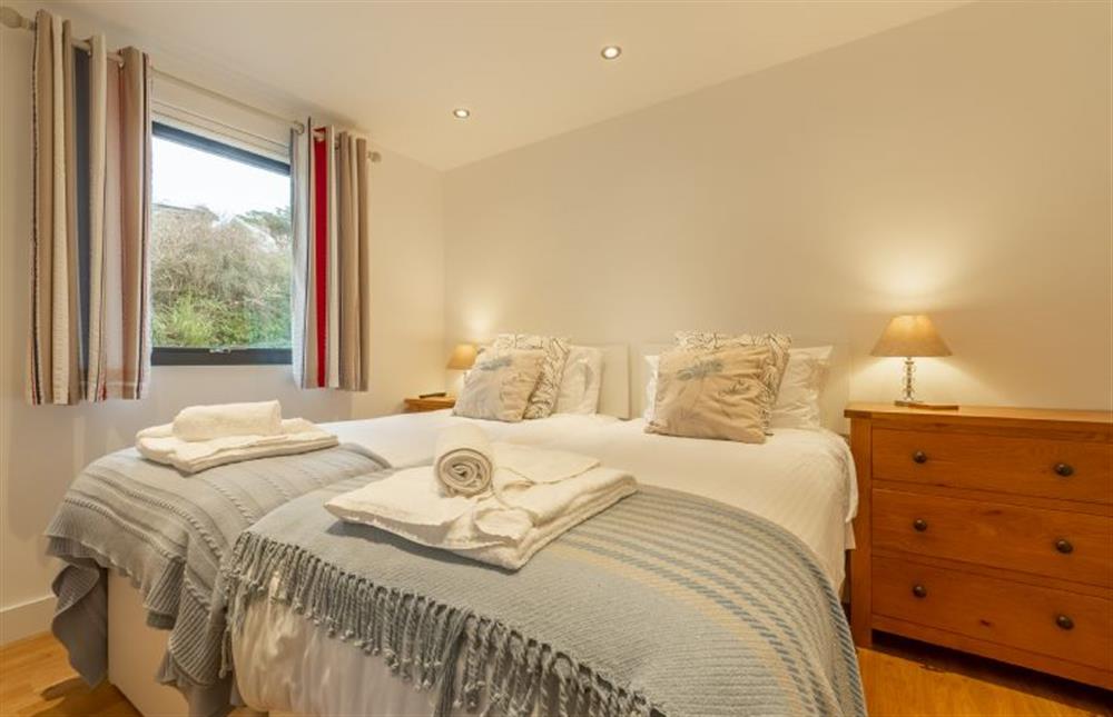 Bedroom two with twin single beds which can be configured as a super-king at Sea Gem, Chapel Porth, St Agnes