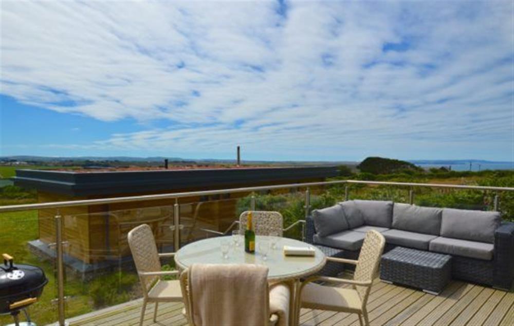 Sea Gem, St Agnes. Large decked area with garden furniture and barbecue at Sea Gem, Chapel Porth, St Agnes