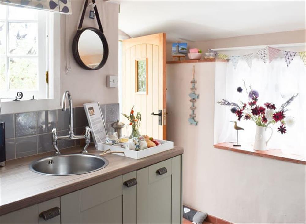 Kitchen with garden access at Sea Glass Cottage in Holcombe, Dawlish, Devon