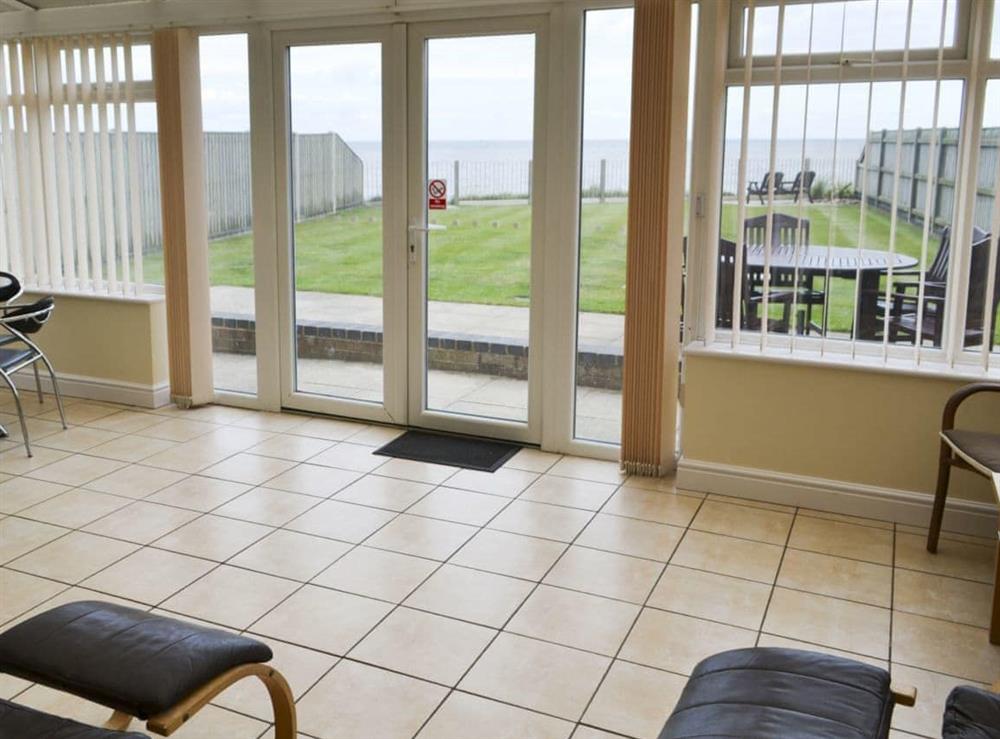 Large conservatory leading to garden and fantastic sea views (photo 2) at Sea Haven in Bacton, Norfolk
