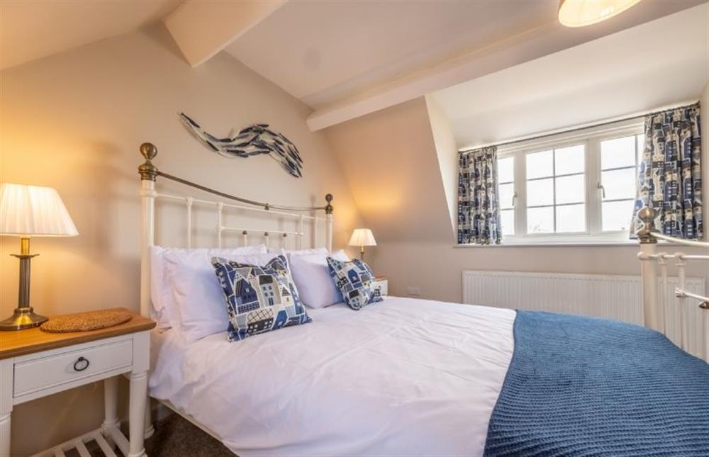 Bedroom two with a glimpse of the sea at Sea Haven, Wells-next-the-Sea