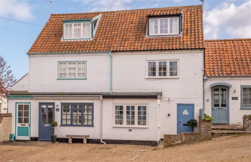 The cottage is one of the pretty white cottages in Brig Square at Sea Haven, Wells-next-the-Sea