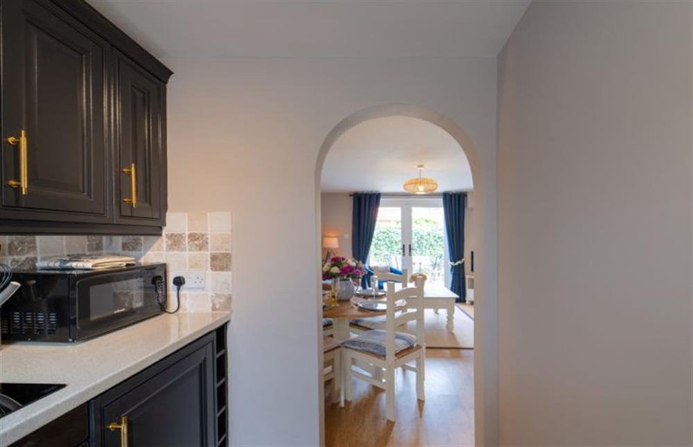 An archway opens to the sitting/dining room (photo 2) at Sea Holly Cottage, Snettisham near Kings Lynn