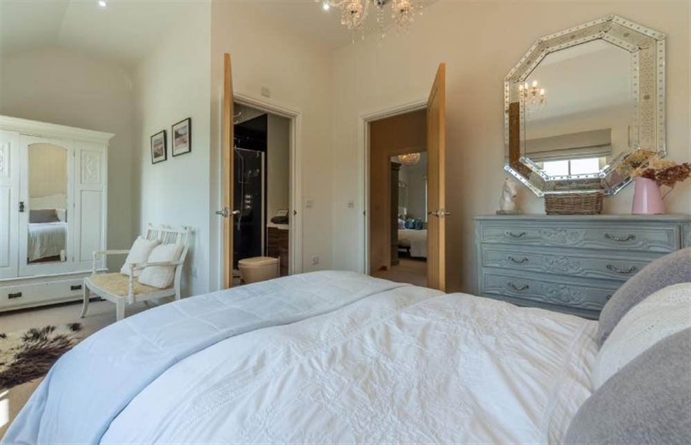 First floor: The Master bedroom has an en-suite shower room at Sea Holly Cottage, Thornham near Hunstanton