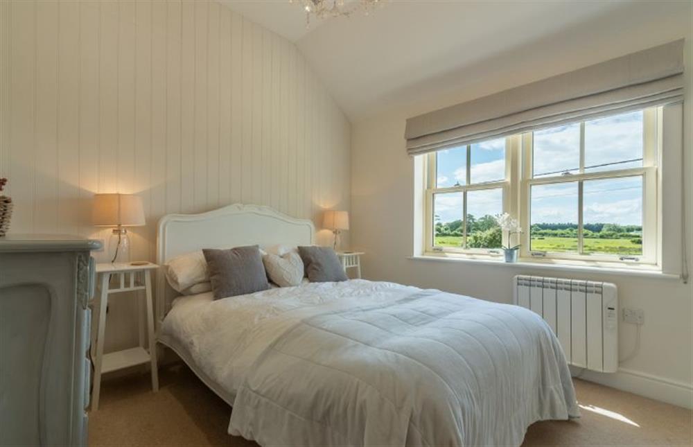 First floor: The Master bedroom has lovely views over the marshes at Sea Holly Cottage, Thornham near Hunstanton