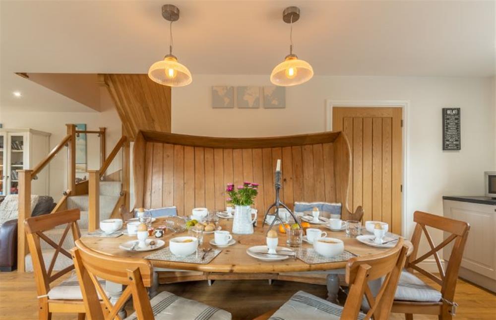 Ground floor: Dining area has old pine curved settle at Sea Holly Cottage, Thornham near Hunstanton