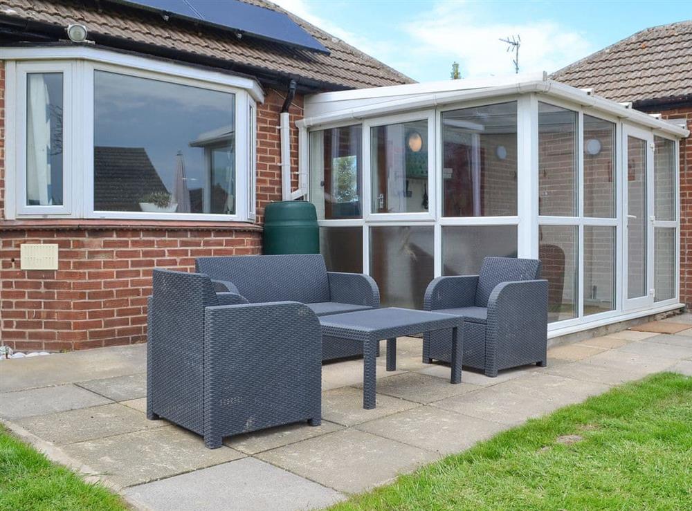Paved patio area with furniture at Sea La Vie in Mundesley, near North Walsham, Norfolk
