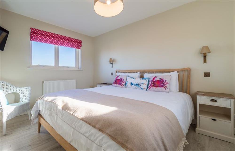 The master bedroom has a super-king bed at Sea Lodge, Brancaster near Kings Lynn