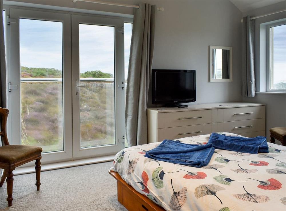 Comfortable double bedroom with Juliet balcony and en-suite (photo 2) at Sea Otter in Porthtowan, Cornwall